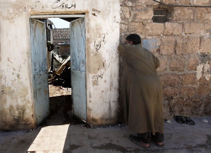 A man cries outside his destroyed home, hit by a government airstrike, in the village of Marea on the outskirts of Aleppo in September 2012.