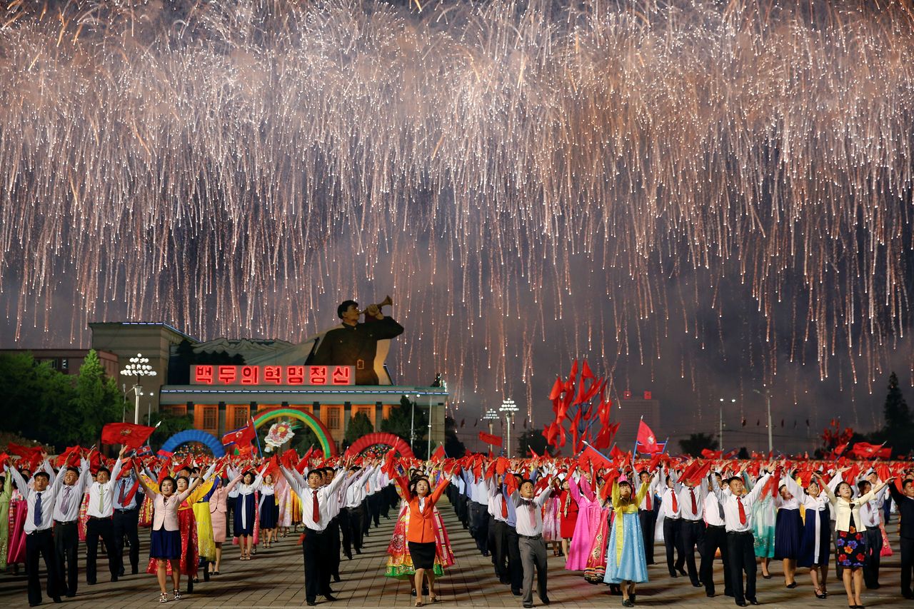 Fireworks explode over a mass dance in the capital's main ceremonial square.