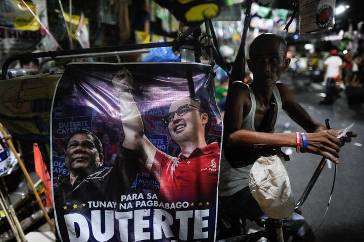 People wait for results in polling centers after voting ended on Monday in Manila, Philippines.