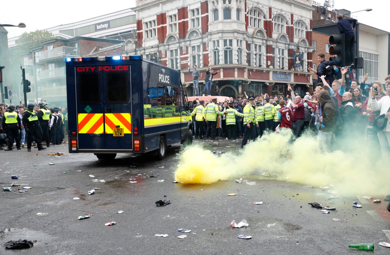 A smoke bomb is let off to control crowds ahead of the Premier League match at Old Trafford