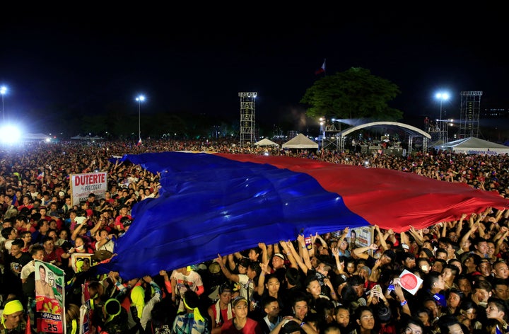 Supporters of Philippines presidential candidate and Davao city mayor Rodrigo 'Digong' Duterte display a huge Philippines flag. Duterte has huge support among the populace in Davao.