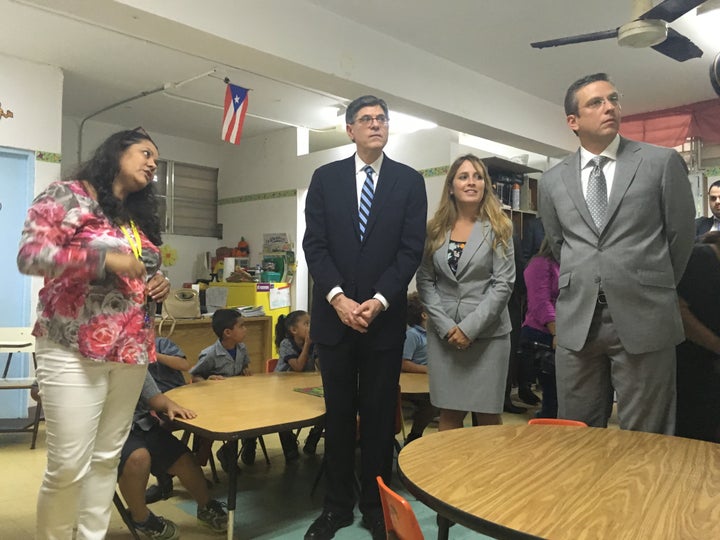 A kindergarten teacher shows Treasury Secretary Jack Lew and Puerto Rican Gov. Alejandro Garcia Padilla termite-infested walls and the crumbling condition of her classroom.