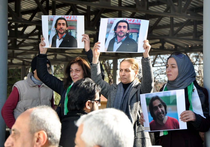 Women hold pictures of anti-ISIS filmmaker Naji Jerf during his funeral in Gaziantep on Dec. 28, 2015. Extremists from the militant group allegedly shot Jerf in the head and chest in broad daylight, killing him.