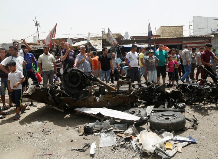 People gather at the scene of a car bomb attack in Baghdad's mainly Shi'ite district of Sadr City, Iraq, May 11, 2016.