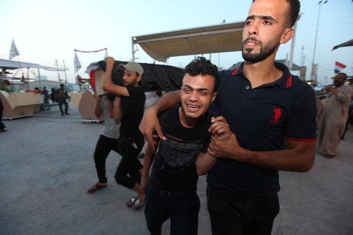 Islamic State suicide bombers killed two policeman in Abu Ghraib on Thursday, a day after a triple bombing took over 80 lives