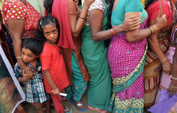 The children of Indian sex workers look on as they participate in a rally at the Sonagachi area of Kolkata on November 8, 201