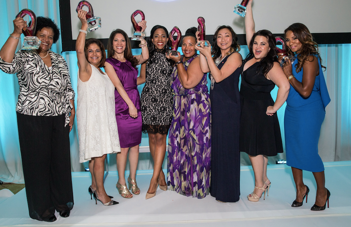 Women of color stand together in celebration of their awards at a ColorComm conference. 