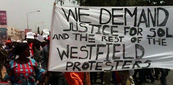 Protesters carry a sign on April 16 demanding justice for opposition members jailed by the Gambian state. Prominent figure Solo Sandeng is believed to have died in police custody.