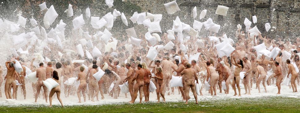 Naked volunteers battle with pillows as they pose for U.S. artist Spencer Tunick in front of the Gaasbeek's Castle on July 9,