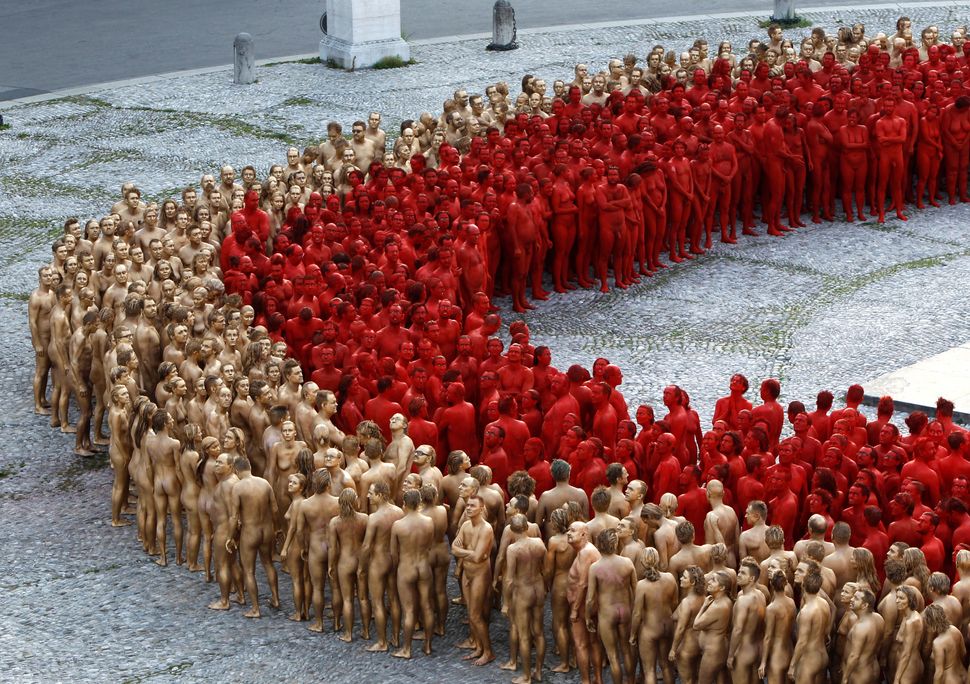 Naked volunteers, numbering around 1,700 people, pose for U.S. artist Spencer Tunick in downtown Munich on June 23, 2012.