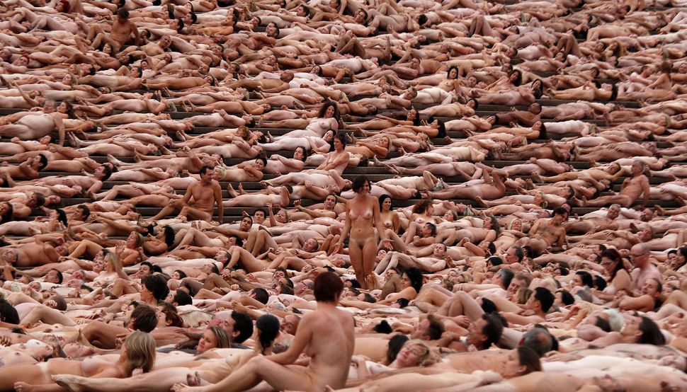 Naked volunteers pose for U.S. artist Spencer Tunick in front of the Sydney Opera House on March 1, 2010. Organizers estimate