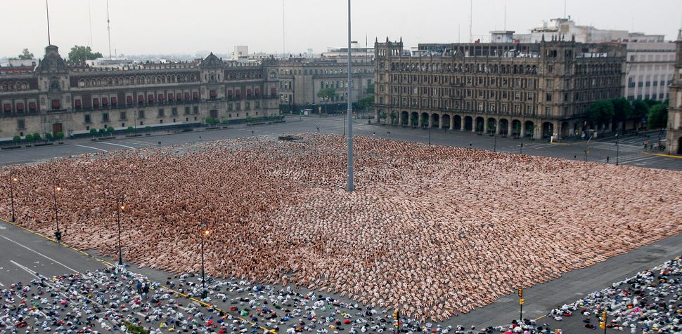 Thousands of naked volunteers pose for U.S. photographer Spencer Tunick at Mexico City's Zocalo square on May 6, 2007. A reco