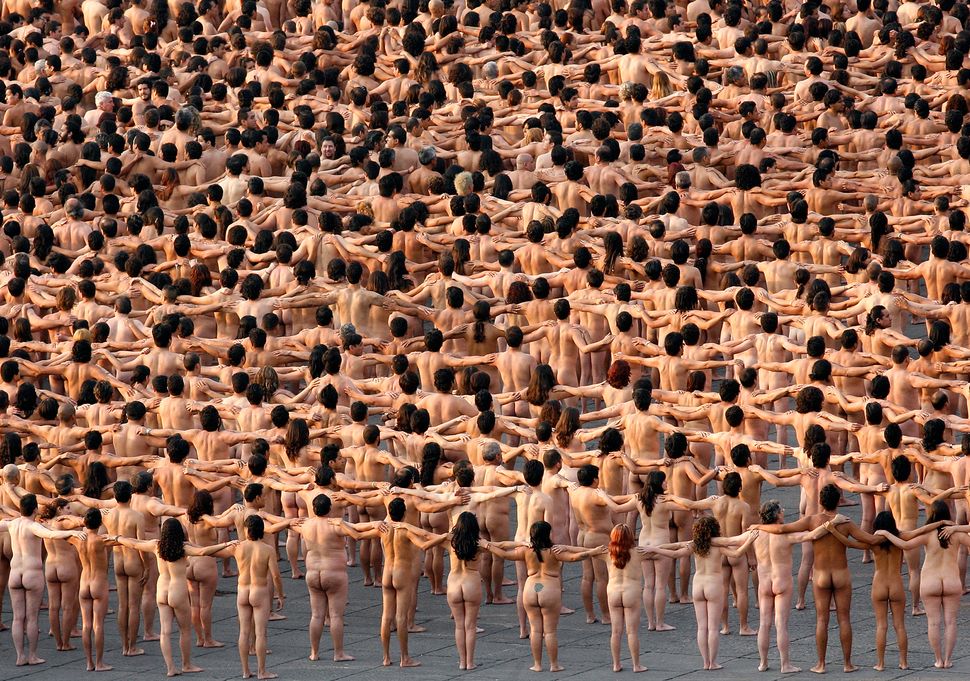 Thousands of naked volunteers pose for U.S. photographer Spencer Tunick at Mexico City's Zocalo square on May 6, 2007. A reco