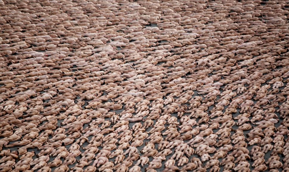 Thousands of naked volunteers pose for U.S. photographer Spencer Tunick at Mexico City's Zocalo square on May 6, 2007. A reco