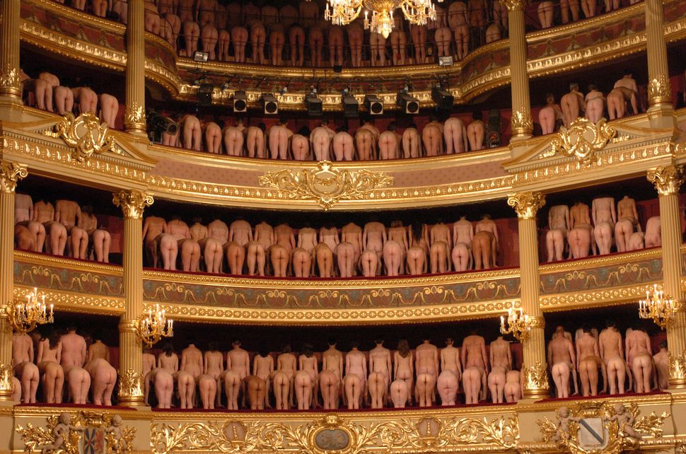 Volunteer participants pose naked inside the Stadschouwburg theatre during a photo session with U.S. photographer Spencer Tun