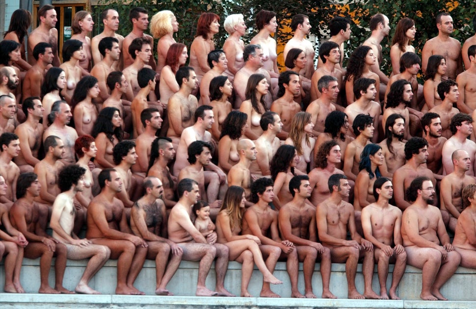 Volunteer participants pose naked during a photo session with American photographer Spencer Tunick in the northern Portuguese