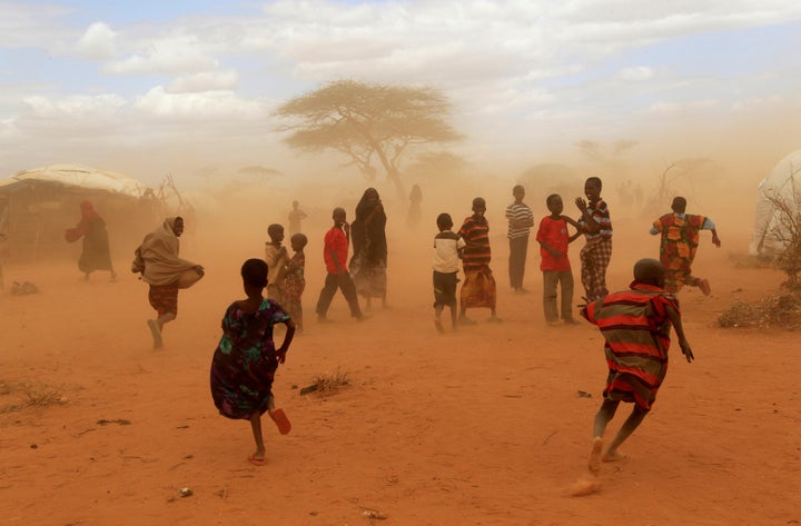 Refugees run from a cloud of dust at the Dagahaley refugee camp in Dadaab.