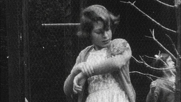 Rare images of the Queen have been released as celebrations to mark the monarch's 90th birthday; she is pictured above with a bird on her arm 