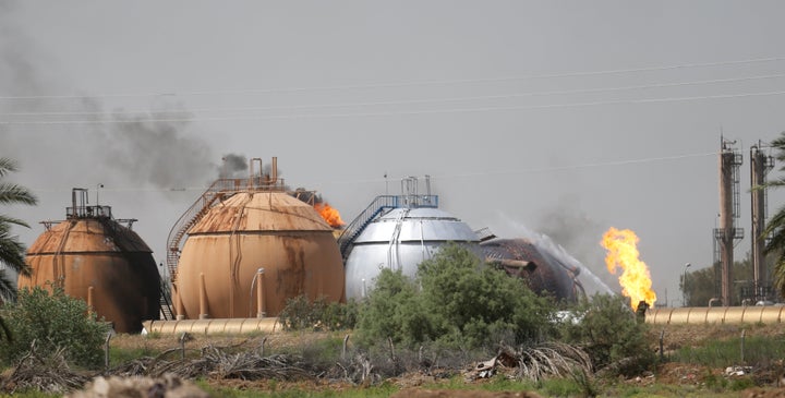 Smoke rises from gas storage tanks after a bomb attack against a state-run cooking gas factory in Taji at Baghdad's northern outskirts, Iraq May 15, 2016.