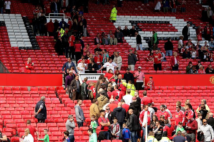 Fans are evacuated from the stands following a security alert and subsequent match abandonment at Old Trafford.