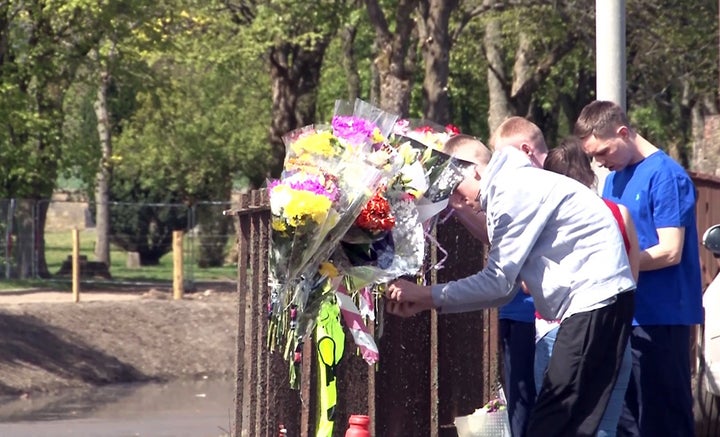 <strong>People leave floral tributes beside the Forth and Clyde Canal</strong>