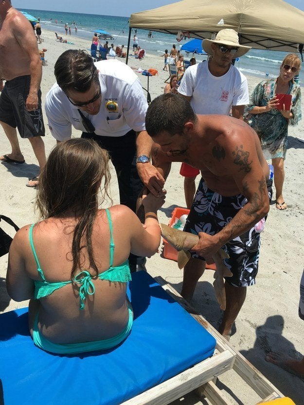 The woman, pictured, had to be taken to a hospital to have the shark removed from her arm.