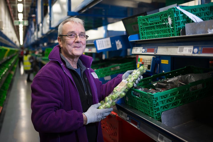 An Ocado staff member packing sprouts at Christmas