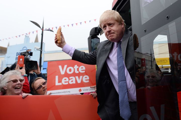 <strong>Johnson brandishes a pasty from the 'Vote Leave' bus as he sets out his vision for a Britain outside the EU</strong>
