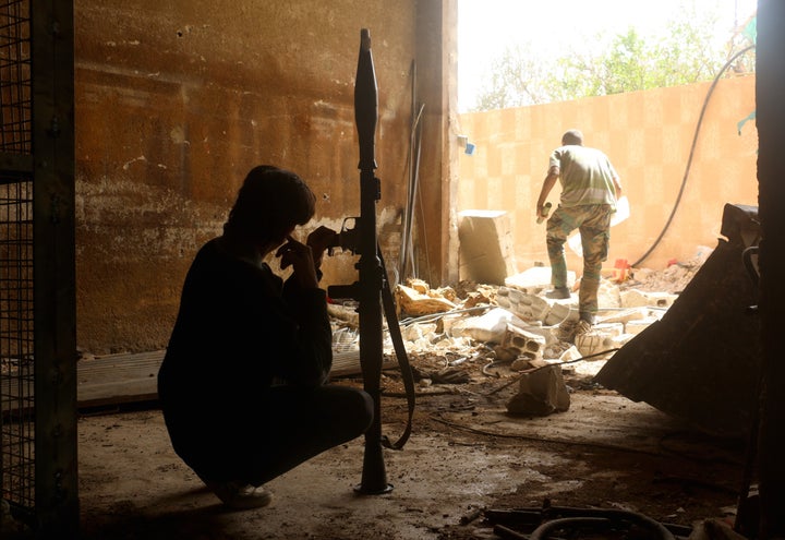 One of the rebel groups controlling Daraya said large convoys of government troops were moving toward Daraya. In this photo, a fighter prepares to take position against regime operations aimed at retaking Daraya.