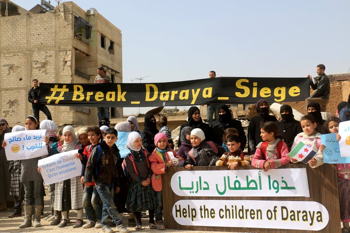 Women and children stage a protest against Assad's regime in Daraya. Government forces turned back an aid convoy that was meant to deliver supplies to the town's civilians last week.