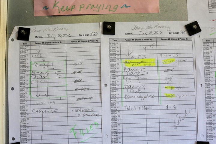 Sign-up sheets on a bulletin board coordinate parishioners keeping vigil at St. Frances Xavier Cabrini Roman Catholic church in Scituate, Massachusetts. 