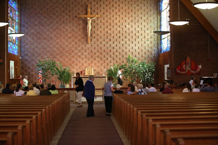 A meeting takes place inside the occupied church.