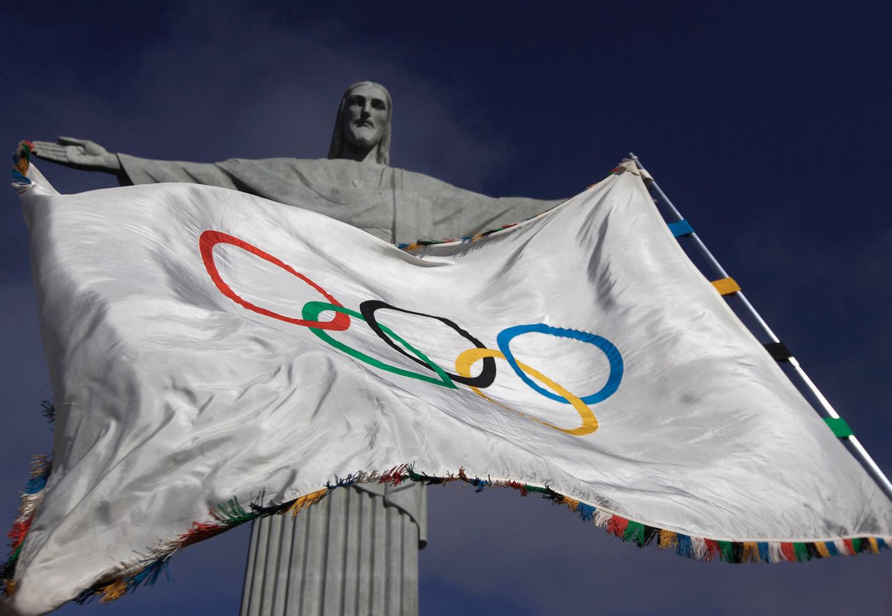 The Olympic flag flies in front of the Christ the Redeemer statue in Rio de Janeiro during a ceremony on Aug. 19, 2012.