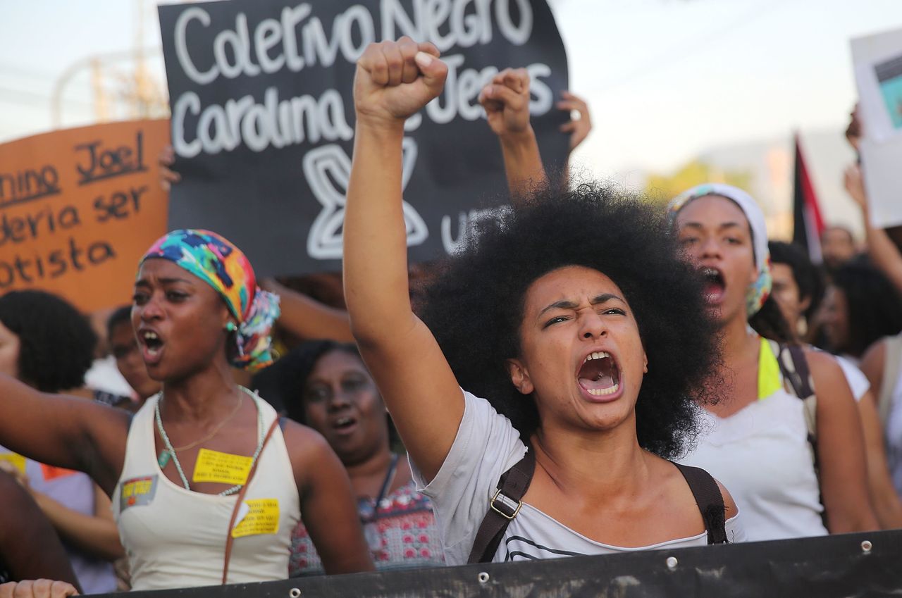 Demonstrators march through Rio de Janeiro's Manguinhos favela to protest police killings on Aug. 22, 2014.