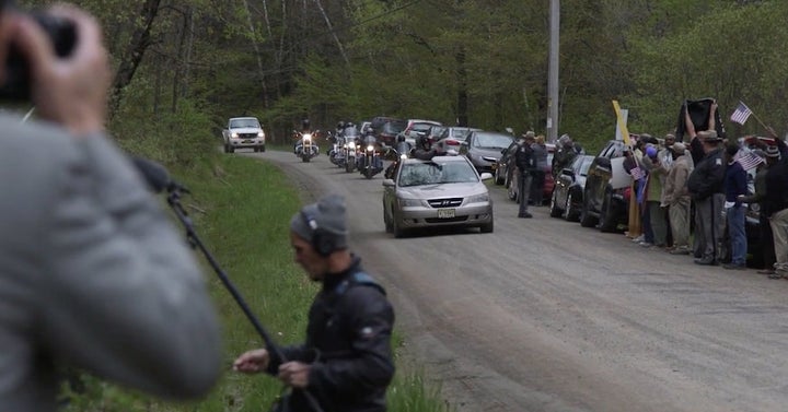 The five bikers rode past counter-protestors who were waving American flags.