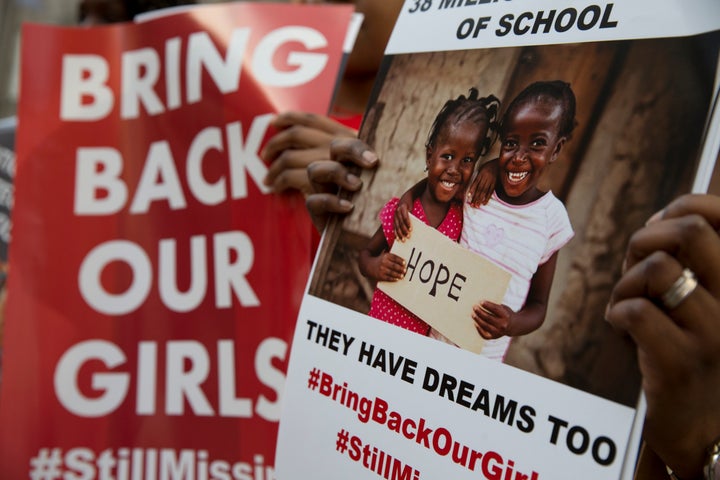 Protesters holds up placards demanding help from the Nigerian government to find hundreds of Chibok girls.