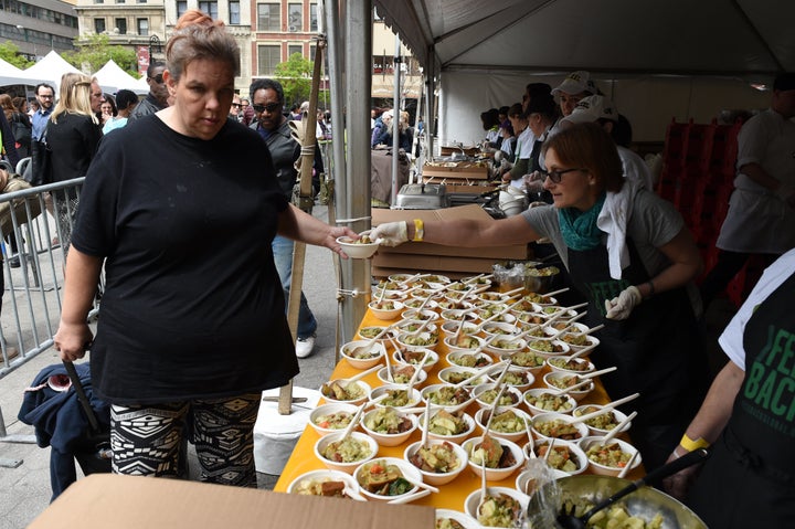 Woman getting some grub at the 'Feeding the 5000 NYC' in Union Square Park.