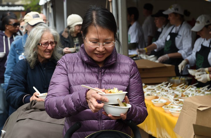 People eat as part of 'Feeding the 5000 NYC' in Union Square Park in May of 2016.