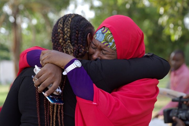 Rights activists named the girl as Amina Ali Darsha Nkeki. Above, #BringBackOurGirls campaigners celebrate the news in Abuja, Nigeria.