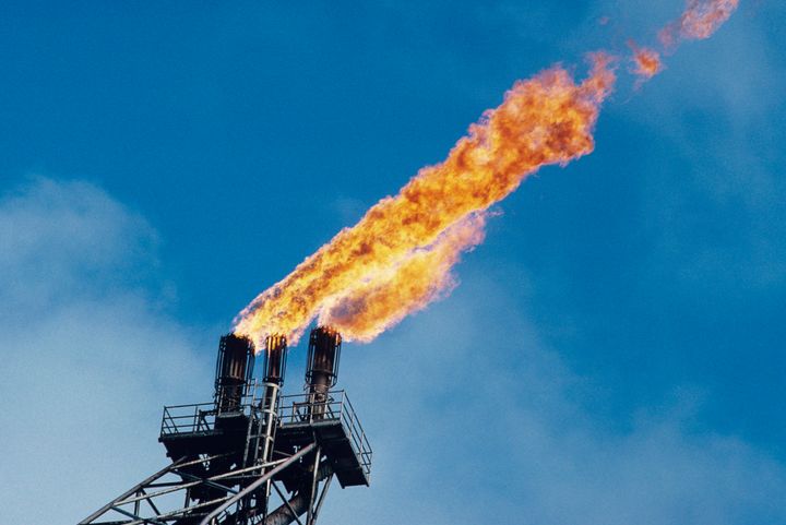"Burn off" oil fume flames are seen on an offshore oil platform. 