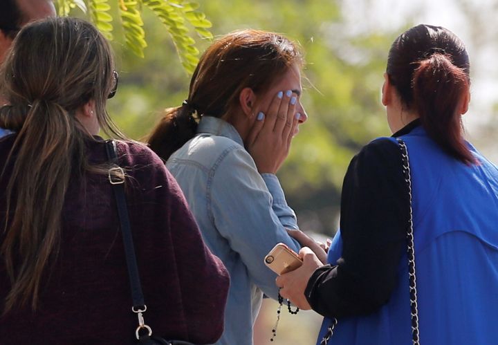 Relatives and friends of passengers who were flying in an EgyptAir plane that vanished from radar en route from Paris to Cairo react as they wait outside the EgyptAir service building.