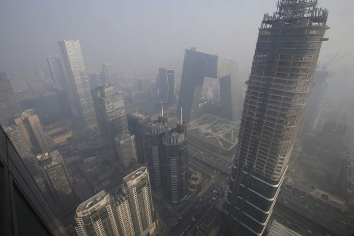 Ammonia fumes from farms mix with other pollutants in the atmosphere to produce fine particle pollutions. Here, buildings are pictured amid the smog in Beijing's central business district, China, Dec. 21, 2015.
