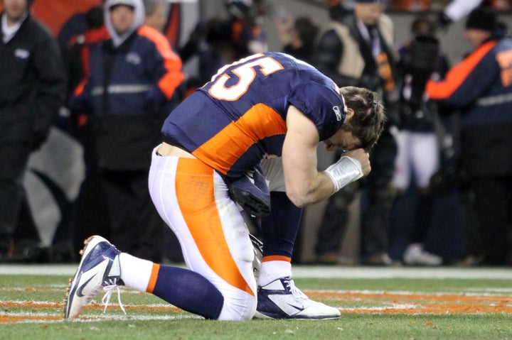 Tim Tebow "tebowing" after a Denver Broncos game in 2012.