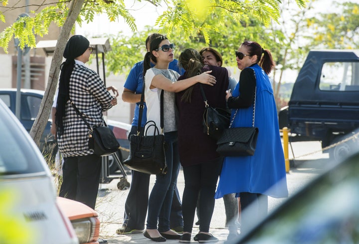 Families of passengers who were flying on board the missing EgyptAir plane wait for news outside a services hall at Cairo international airport.