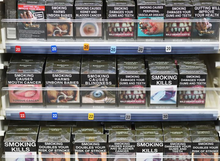 Cigarettes are being sold in standardised green packaging bearing graphic warnings of the dangers of smoking from today; pictured above are cigarettes being sold in Australia where the directive has been in place since 2012