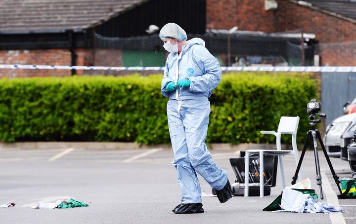 A forensics officer examines evidence at the scene