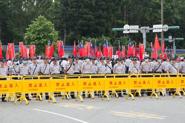 Police in Taipei stand guard at Tsai's inauguration. Tsai also proposed that Taiwan and China set aside disputes over control over the South China Sea "to enable joint development."