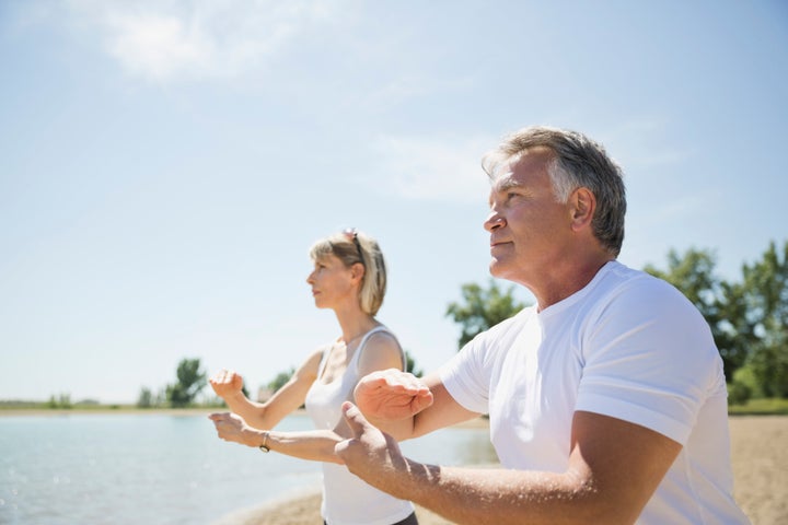 Middle-aged couple performing tai chi.