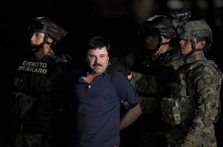 Drug kingpin Joaquin 'El Chapo' Guzman is escorted to a helicopter at Mexico City's airport following his recapture in January. 