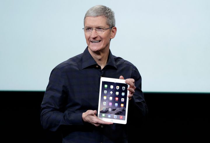 Apple CEO Tim Cook holds an iPad Air 2.